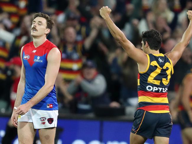 ADELAIDE, AUSTRALIA - MAY 22: Jake Lever of the Demons reacts on the siren after the loss as Shane McAdam of the Crows raises his arms in victory during the 2021 AFL Round 10 match between the Adelaide Crows and the Melbourne Demons at Adelaide Oval on May 22, 2021 in Adelaide, Australia. (Photo by Sarah Reed/AFL Photos via Getty Images)