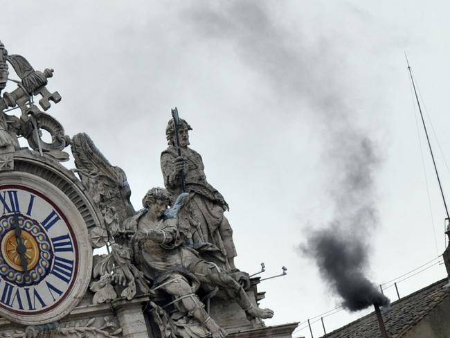 13/03/2013 WIRE: Black smoke rises from the chimney on the roof of the Sistine Chapel meaning that cardinals failed to elect a new pope in the second ballot of their secret conclave on  March 13, 2013 at the Vatican. The 115 cardinals vote in the Sistine Chapel in a process of finding a successor to Benedict XVI, who brought a troubled eight-year papacy to an abrupt end by resigning last month.  AFP PHOTO / TIZIANA FABI Pic. Afp
