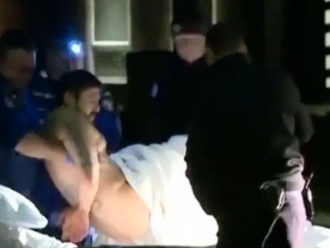 Lone Wolf bikie Erkan Keskinis is treated by paramedics after being arrested. Picture: Seven News