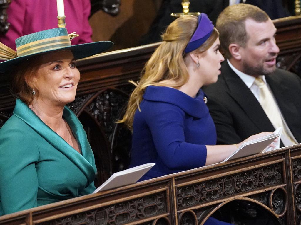Sarah Ferguson, left, Princess Beatrice and Peter Phillips take their seats ahead of the wedding of Princess Eugenie of York and Jack Brooksbank.  Picture:  AP