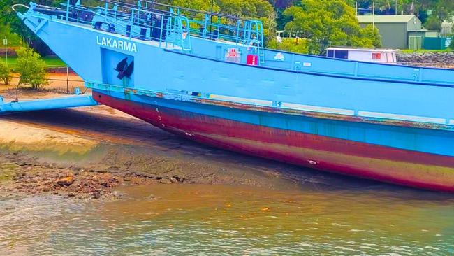 The Sealink barge Lakarma unable to float away from the Russell Island landing.