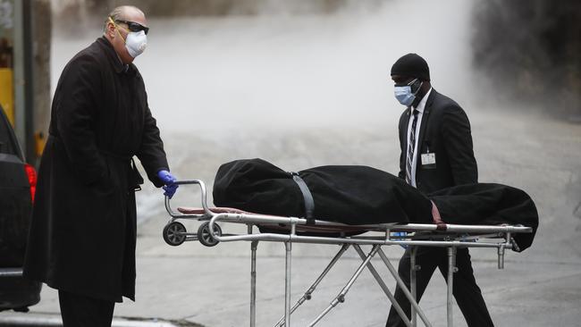 A funeral director wears personal protective equipment due to COVID-19 concerns while collecting a body at The Brooklyn Hospital Center. Picture: AP