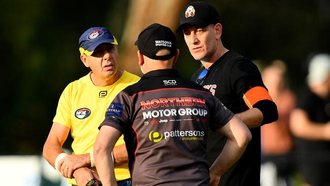 Umpire head Martin Ellis speaks with Watsonia coach George Lattouf and Panton Hill coach Simon Amore. Picture: Josh Chadwick