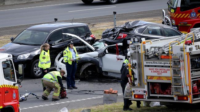 Tasmania Police, Tasmania Fire Service and Tasmania Ambulance Service crews at the scene of the four-vehicle crash on the Tasman Highway at Mornington yesterday. Picture: LUKE BOWDEN