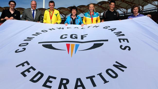 Jann Stuckey (fourth from left), Minister for Tourism, Major Events and Small Business, Mark Peters (second from left), CEO, Gold Coast 2018 Commonwealth Games with athletes Jake Duffy (left), Michael Shelley, Melanie Schlanger, Wesley Caulkett and Wade Townsend during the unveiling of the games flag at Metricon Stadium in Carrara, Gold Coast. Picture: Regi Varghese