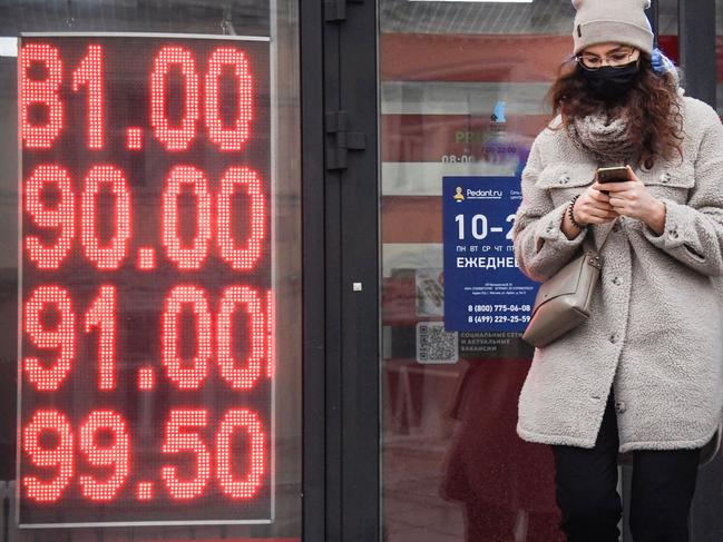 A woman walks past a currency exchange office in central Moscow on February 24, 2022. Picture: Alexander Nemenov/AFP