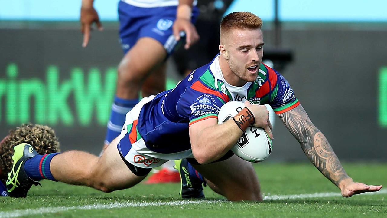 Adam Keighran of the Warriors scores a try.