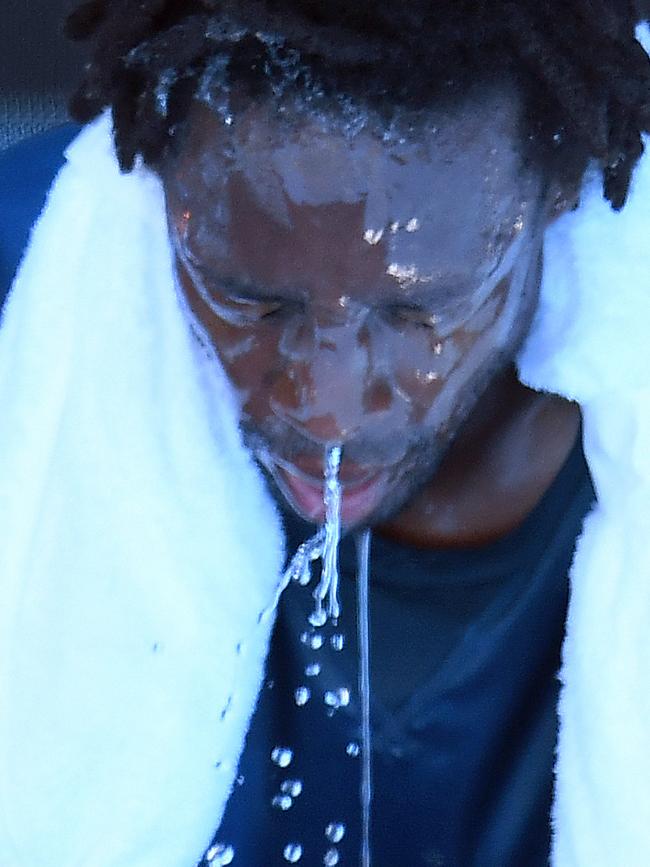 Gael Monfils pours water all over his head during a break.