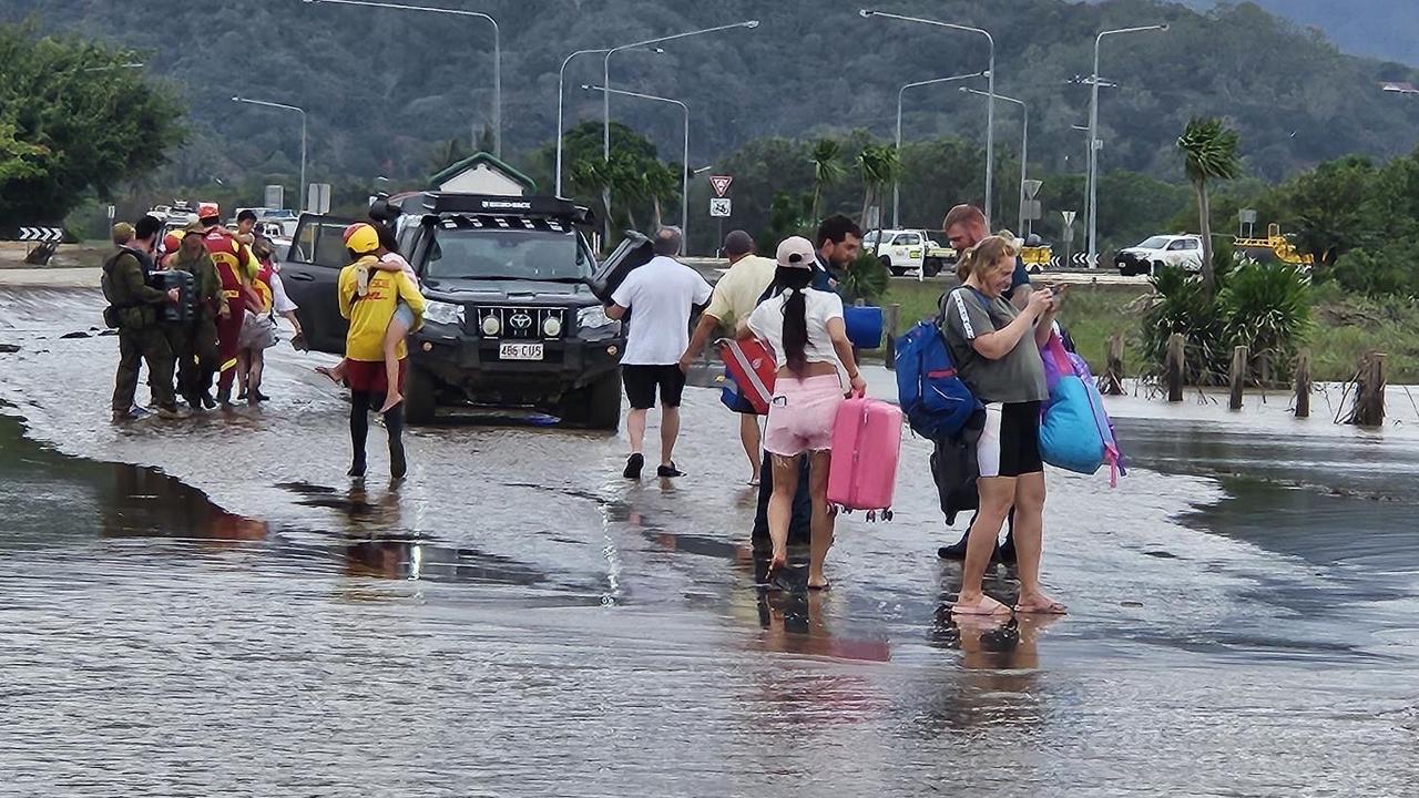 Australian Army soldiers from 51st Battalion, Far North Queensland Regiment, assist personnel from the Queensland Police Swift Water Rescue team and Surf Life Saving Queensland with recovery operations in Cairns' Northern Beaches on 18 December 2023. Picture: ADF