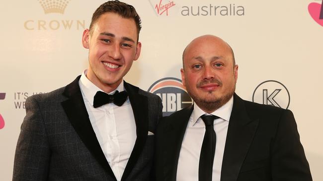 A younger Justin with dad Larry Kestelman at an NBL basketball launch. Picture: Julie Kiriacoudis