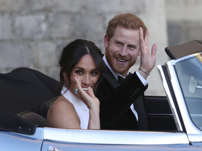 The newly married Duke and Duchess of Sussex, Meghan Markle and Prince Harry, leave Windsor Castle for Frogmore House in a converted electric car. Picture: AP