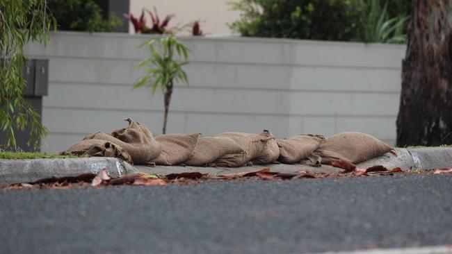 A homeowner in Sawtell prepares for this weekend's wet weather by placing sandbags at the end of the driveway. Flood, Coffs Harbour Photo: Tim Jarrett