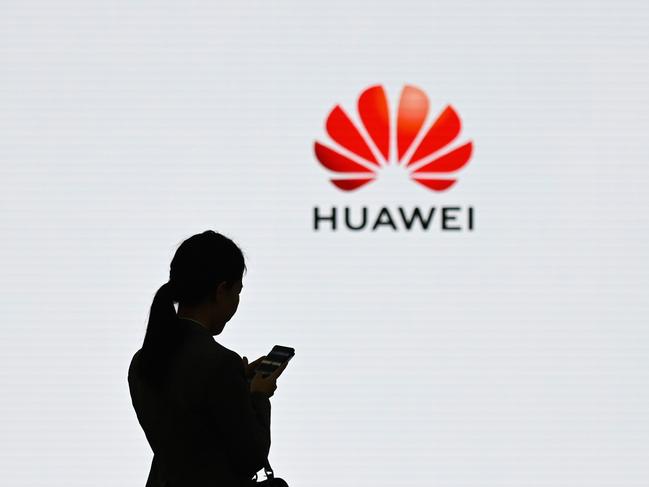 (FILES) This file photo taken on March 6, 2019 shows a staff member of Huawei using her mobile phone at the Huawei Digital Transformation Showcase in Shenzhen, China's Guangdong province. - Huawei has overtaken Samsung to become the number one smartphone seller worldwide in the second quarter this year, industry tracker Canalys said on July 30, 2020. (Photo by WANG ZHAO / AFP)