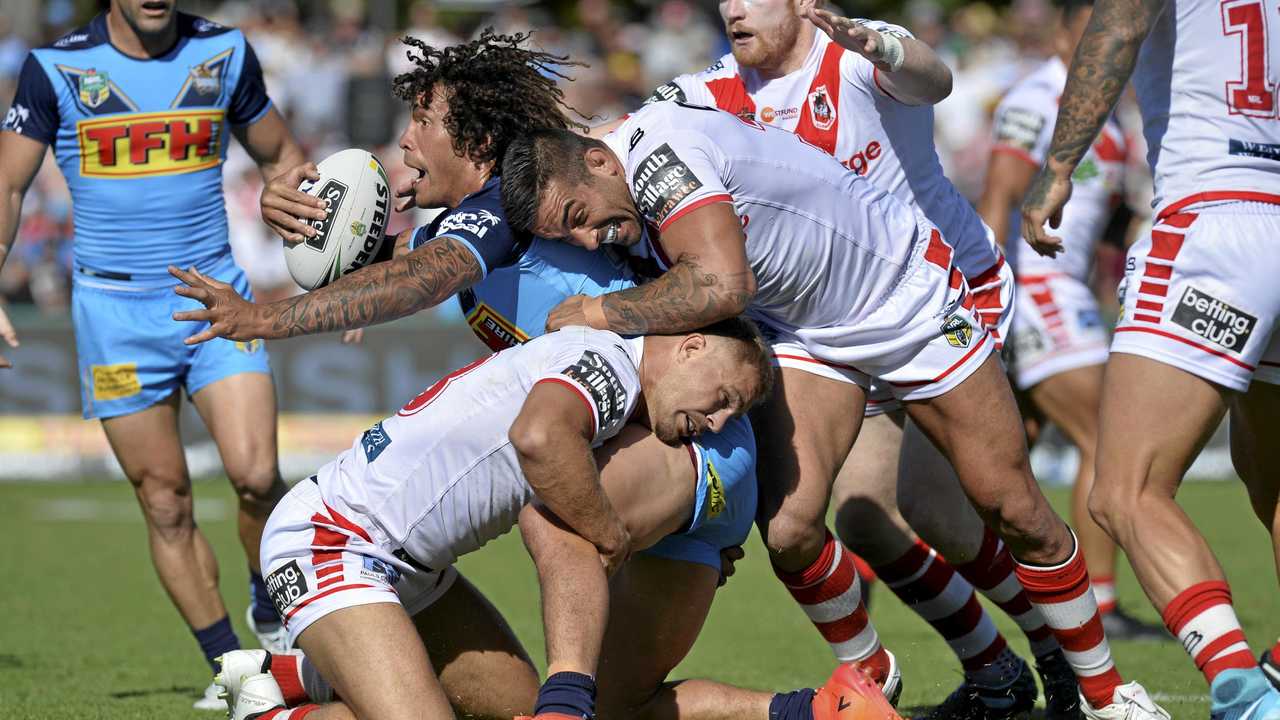 TACKLED: Gold Coast Titans prop Kevin Proctor is wrapped up by the Dragons defence. Picture: Kevin Farmer