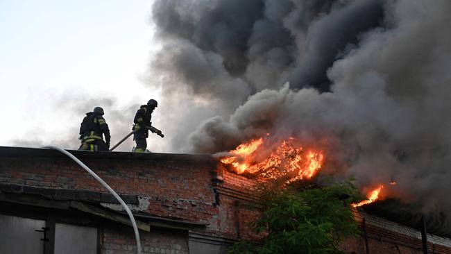Ukrainian rescuers work to extinguish a fire in a building following an air-attack in Kharkiv on June 4. Picture: AFP