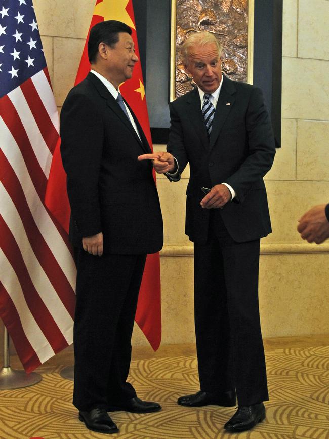 US Vice President Joe Biden reacts as he is directed to a position for photos with Chinese Vice President Xi Jinping before talks in Beijing in 2011.