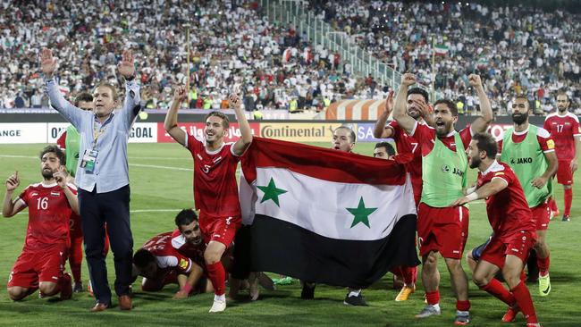 Syria's players celebrate at the end of their FIFA World Cup 2018 qualification football match.