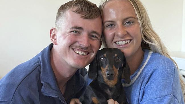 Josh Fishlock and Georgia Gardner hold Valerie, their miniature dachshund after being reunited on Kangaroo Island in South Australia after Valerie was missing for 529 days. Picture: Ruby Stewart