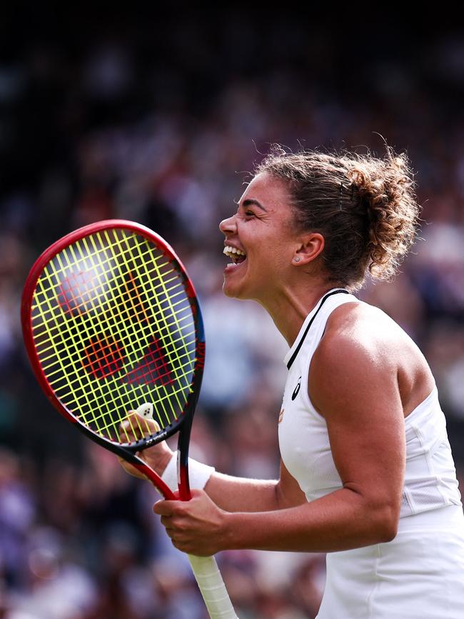 The Italian celebrates after winning match point. (Photo by Henry Nicholls/AFP)