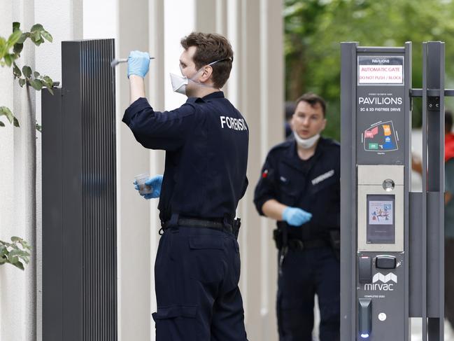 Forensics pictured dusting for prints on a gate at the front an apartment building on Figtree Drive in Sydney Olympic park where a man was shot around 3am this morning. Picture: NewsWire / Damian Shaw