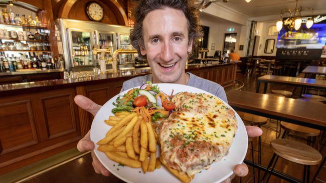 Nick Sando with a magnificent example of the schnitzel parmigiana. Picture: Kelly Barnes