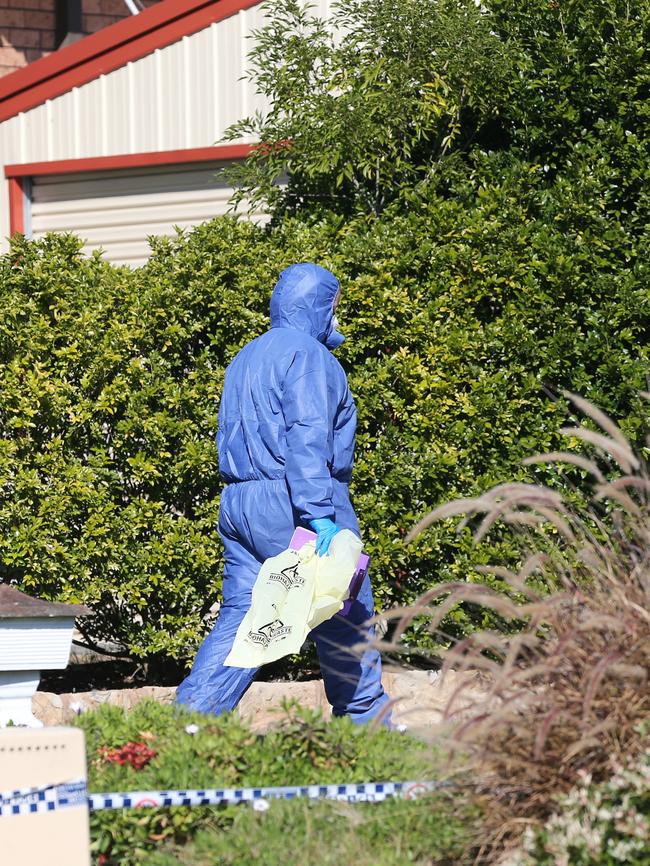 Investigators at the crime scene where the young woman was found dead. Picture: Peter Lorimer