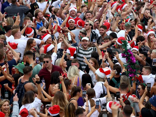 A crowd of mostly backpackers hold an impromptu party at Bronte Beach on Christmas Day with police in attendance to move the large crowd on who were breaching the Covid-19 social distancing rules. Picture: Toby Zerna