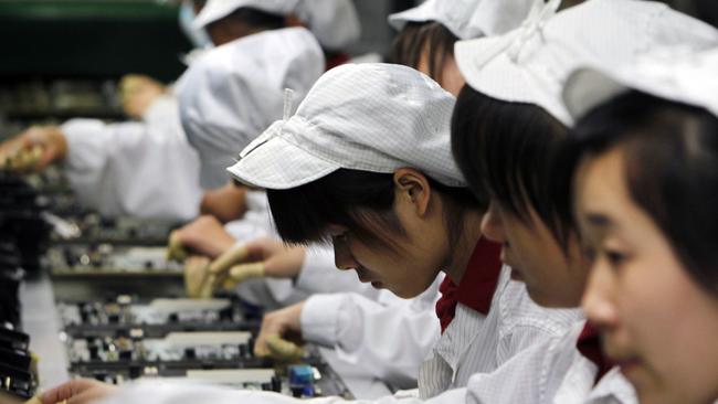 FILE-In this Wednesday, May 26, 2010, file photo, staff members work on the production line at the Foxconn complex in Shenzhen, China. Foxconn, the company that makes Apple's iPhones suspended production at a factory in China on Monday, Sept. 24, 2012, after a brawl by as many as 2,000 employees at a dormitory injured 40 people. The fight, the cause of which was under investigation, erupted Sunday night at a privately managed dormitory near a Foxconn Technology Group factory in the northern city of Taiyuan, the company and Chinese police said.(AP Photo/Kin Cheung, File)