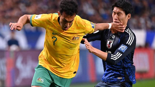 SAITAMA, JAPAN - OCTOBER 15: Nishan Velupillay of Australia controls the ball against Daichi Kamada of Japan during the FIFA World Cup Asian Third Qualifier Group C match between Japan and Australia at Saitama Stadium on October 15, 2024 in Saitama, Japan.  (Photo by Kenta Harada/Getty Images)