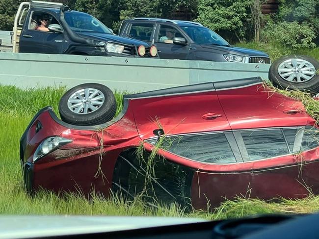 Traffic banked for 10km after car rolls on Bruce Hwy