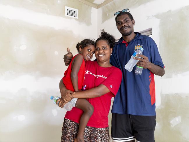 Kara Munyarryun and Jamsie Gurruwiwi with their daughter Kyriesha stand in the nearly finished independent Youth Centre which their daughter will use. Picture: Floss Adams.