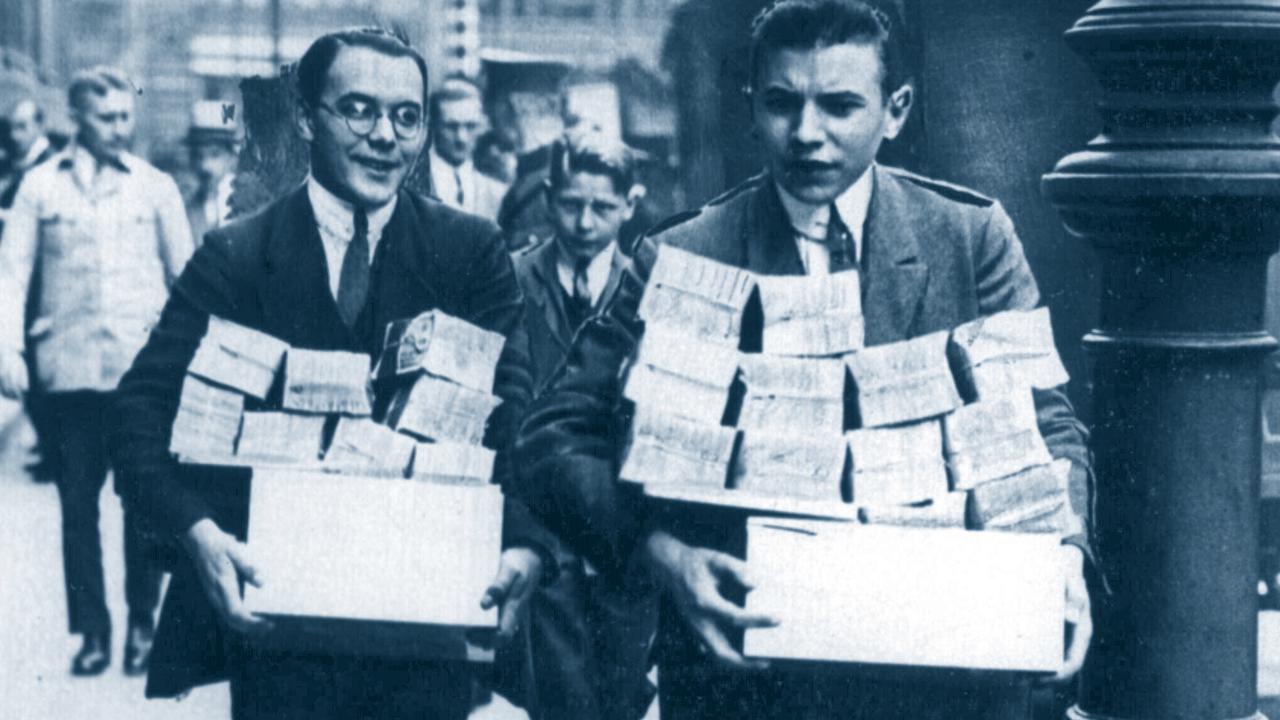 German workers taking home bundles of cash money dollars, their daily wage due to inflation during the depression of 1920s in Germany.