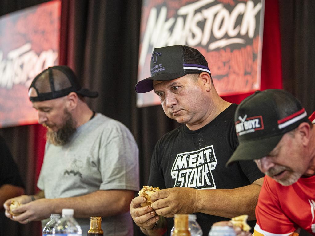 Paul Sulley (centre) during the Phat Boyz Slider Throwdown eating competition at Meatstock at Toowoomba Showgrounds, Sunday, March 10, 2024. Picture: Kevin Farmer