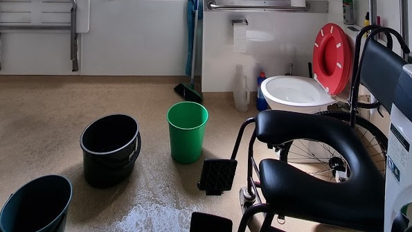 Buckets on the floor of Jason East's Parramatta Park unit to collect shower water dripping from above. Picture: Supplied