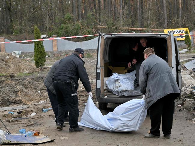 Ukrainian rescuers load the bodies which were discovered in a manhole at a petrol station in the outskirts of the Buzova village, west of Kyiv. Picture: AFP