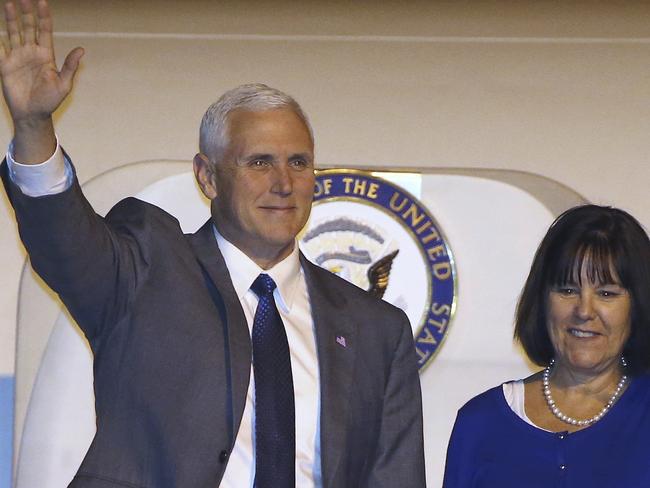 US Vice President Mike Pence, left, and his wife Karen wave as they arrive in Sydney.