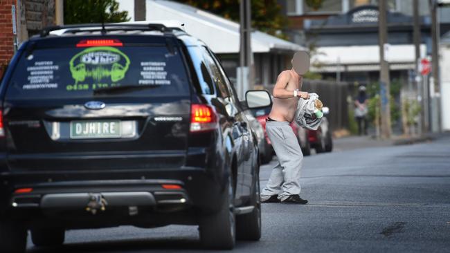 A man, who appears drug-affected, stops traffic in a Richmond street. Picture: Tony Gough