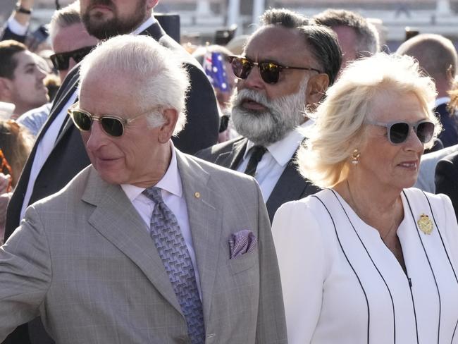 SYDNEY, AUSTRALIA - OCTOBER 22: Britain's King Charles III, second from right, reaches out to greet the crowd as Queen Camilla stands beside him during their visit to the Sydney Opera House on October 22, 2024 in Sydney, Australia. The King's visit to Australia is his first as monarch, and the Commonwealth Heads of Government Meeting (CHOGM) in Samoa will be his first as head of the Commonwealth. (Photo by Mark Baker - Pool/Getty Images)