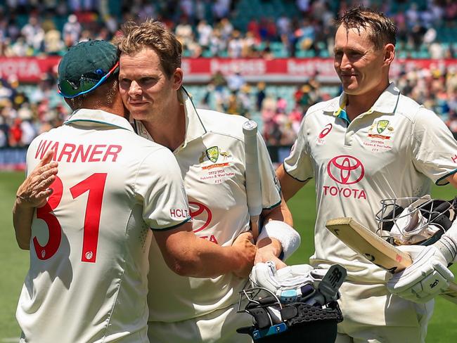 SYDNEY, AUSTRALIA - JANUARY 06: David Warner of Australia (L) is congratulated by Steve Smith of Australia as Marnus Labuschagne of Australia(R) looks on after their win during day four of the Men's Third Test Match in the series between Australia and Pakistan at Sydney Cricket Ground on January 06, 2024 in Sydney, Australia. (Photo by Mark Evans/Getty Images)