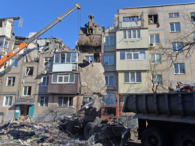 Rescuers remove debris from a residential building damaged by shelling in Kharkiv. Picture: AFP