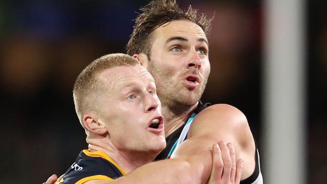 ADELAIDE, AUSTRALIA - AUGUST 20: Reilly O'Brien of the Crows and Jeremy Finlayson of the Power during the 2022 AFL Round 23 match between the Port Adelaide Power and the Adelaide Crows at Adelaide Oval on August 20, 2022 in Adelaide, Australia. (Photo by Sarah Reed/AFL Photos via Getty Images)