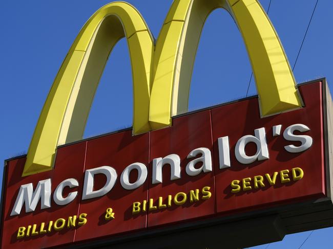 A McDonald's sign is seen above the fast food restaurant on Monday, Nov. 25, 2019 near downtown Los Angeles. McDonald's has agreed to a $26 million settlement of a long-running class-action lawsuit over wages and work conditions at corporate-run locations in California. (AP Photo/Richard Vogel)