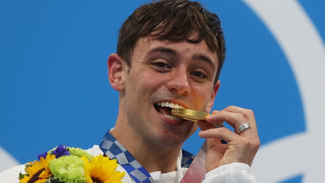 TOKYO, JAPAN - JULY 26: Tom Daley of Team Great Britain poses with the gold medal during the medal presentation for the Men's Synchronised 10m Platform Final on day three of the Tokyo 2020 Olympic Games at Tokyo Aquatics Centre on July 26, 2021 in Tokyo, Japan. (Photo by Clive Rose/Getty Images)