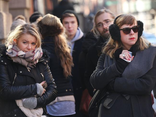 Saying goodbye ... New Yorkers brave the cold to pay tribute to David Bowie at a memorial outside his apartment. Picture: Spencer Platt/Getty Images/AFP