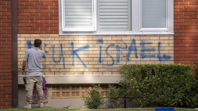 A worker cleans off graffiti on a Woollahra apartment block last Thursday. Picture: Jeremy Piper