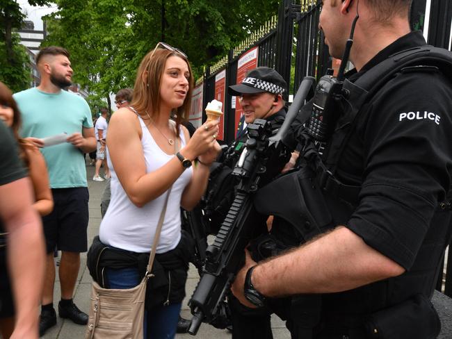 A woman offers her ice cream to a police officer as armed police patrol around Old Trafford Cricket Ground ahead of an earlier concert, by the Courteeners. Security has been dramatically increased since the Manchester Arena suicide bombing which killed 22 people. Picture: Anthony Devlin / Getty