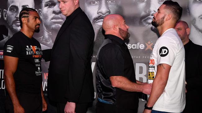British boxers David Haye (L) and Tony Bellow (R) are separated by security personnel.
