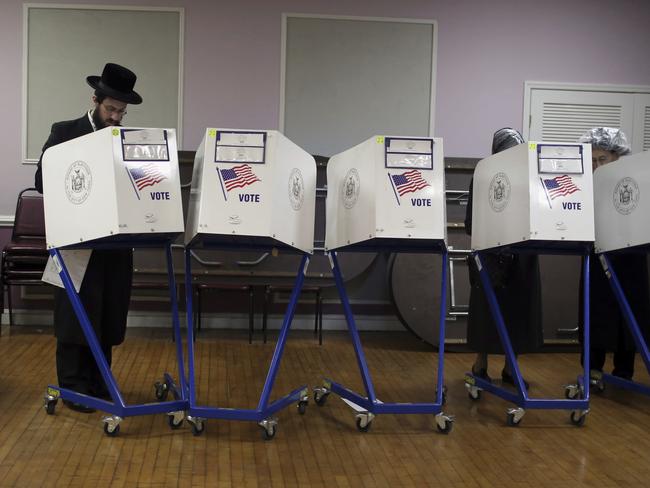 Members of the orthodox Jewish community fill out ballot papers at a polling centre in Brooklyn. Picture: AP