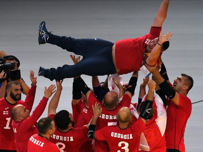 The Georgian team celebrates their victory against the United Kingdom in the final of the sitting volleyball event. Picture: Saeed Khan/AFP