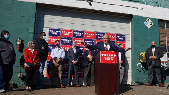 Rudy Giuliani, speaks at a news conference in the parking lot of a Four Seasons landscaping company on November 7. It was billed as a major press event at Philadelphia's Four Seasons but a briefing by Donald Trump's lawyers was mercilessly mocked when it emerged the venue was not the plush hotel but a suburban garden centre between a crematorium and a sex shop. Picture: Bryan R. Smith/AFP